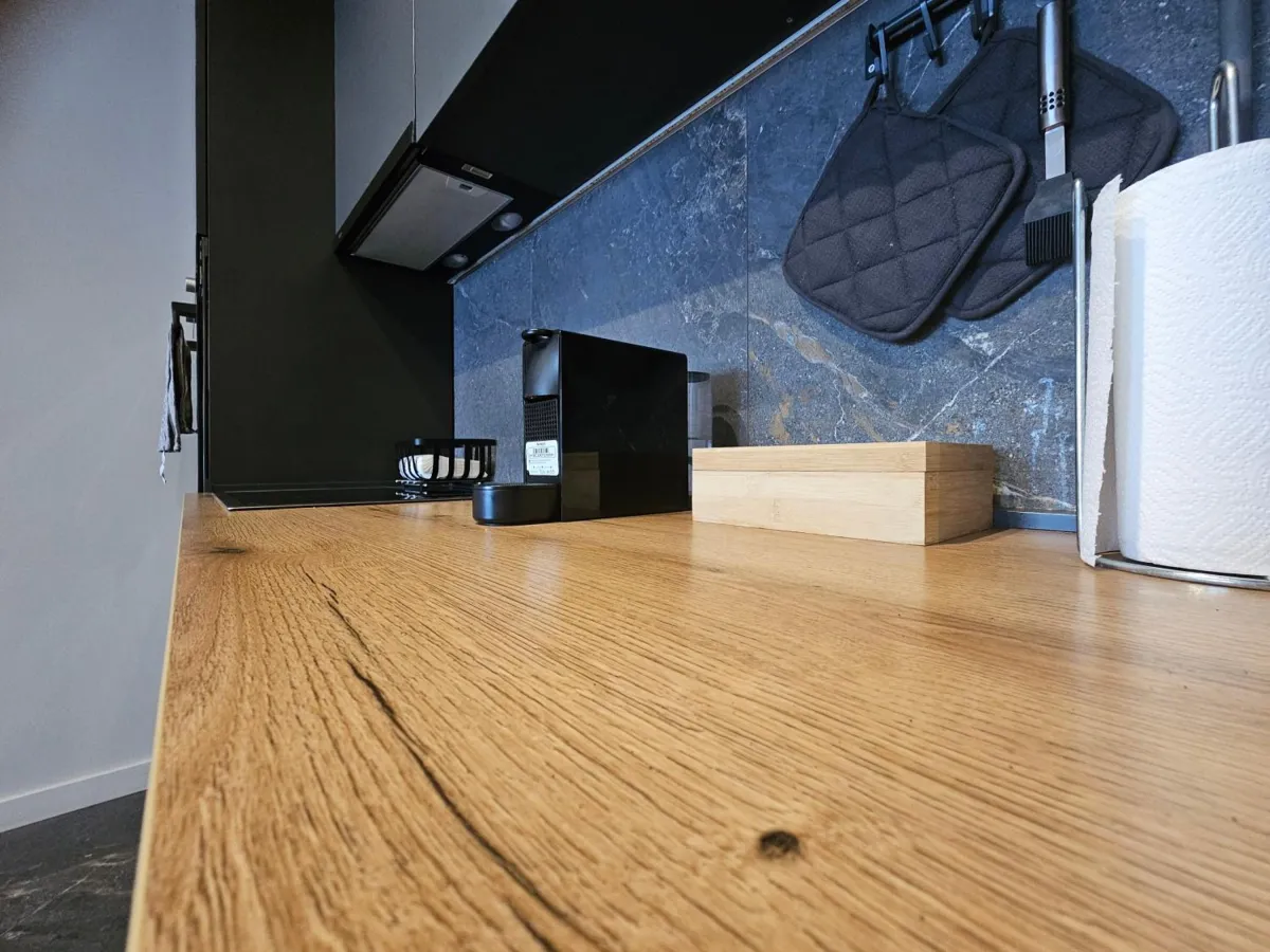 Kitchen with oak worktop and espresso machine in West Side 99